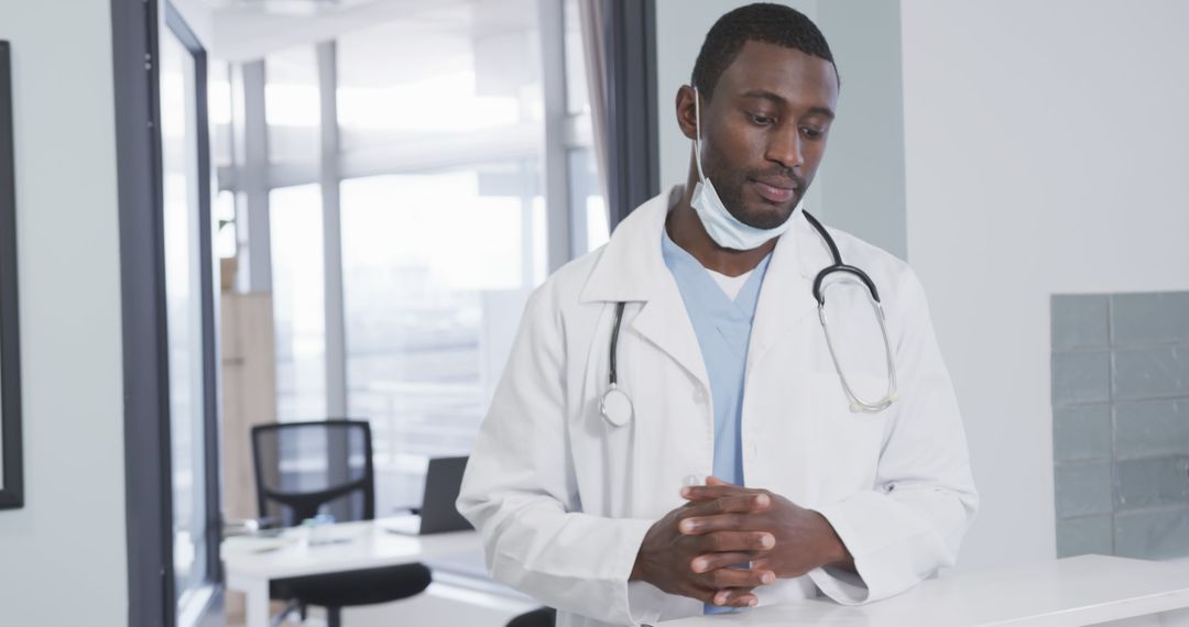 Young African American Doctor Standing in Modern Hospital Reception - Free Images, Stock Photos and Pictures on Pikwizard.com