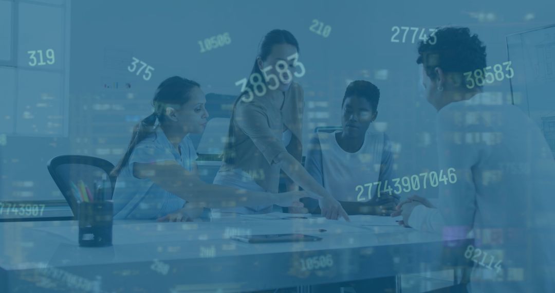 Diverse Female Professionals Analyzing Business Data at Office Desk