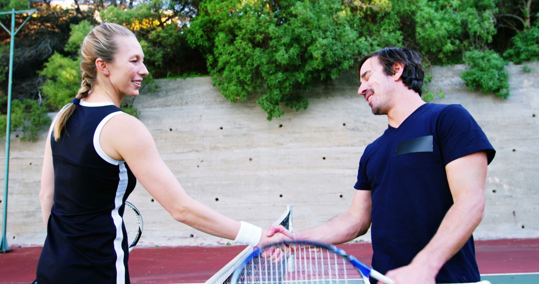 Friendly Tennis Interaction Between Opponents Shaking Hands After Match - Free Images, Stock Photos and Pictures on Pikwizard.com