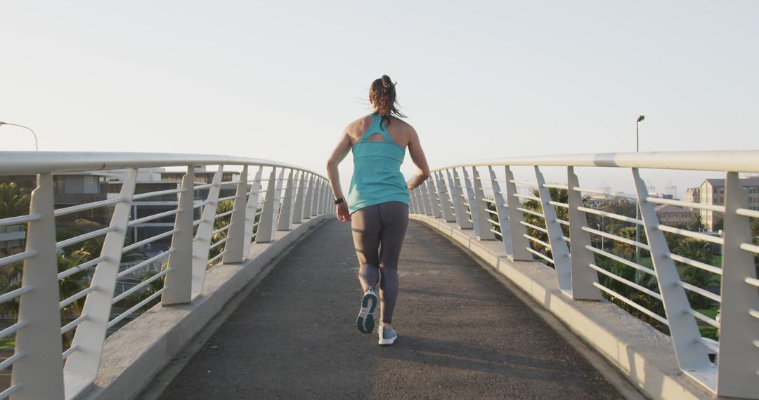 Woman Jogging on Pedestrian Bridge at Sunrise - Free Images, Stock Photos and Pictures on Pikwizard.com