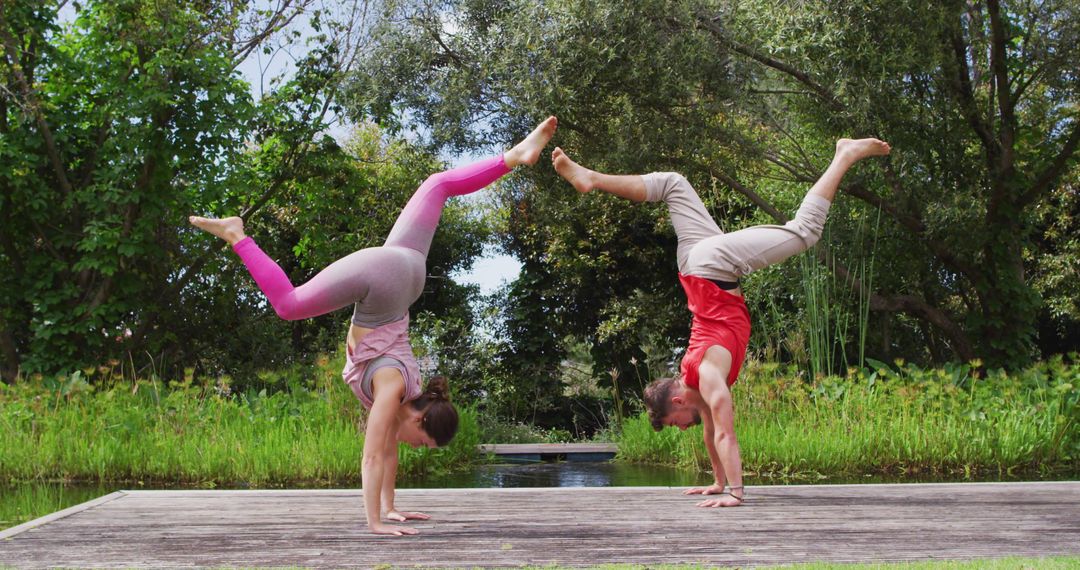 Couple Practicing Handstands in Outdoor Yoga Session