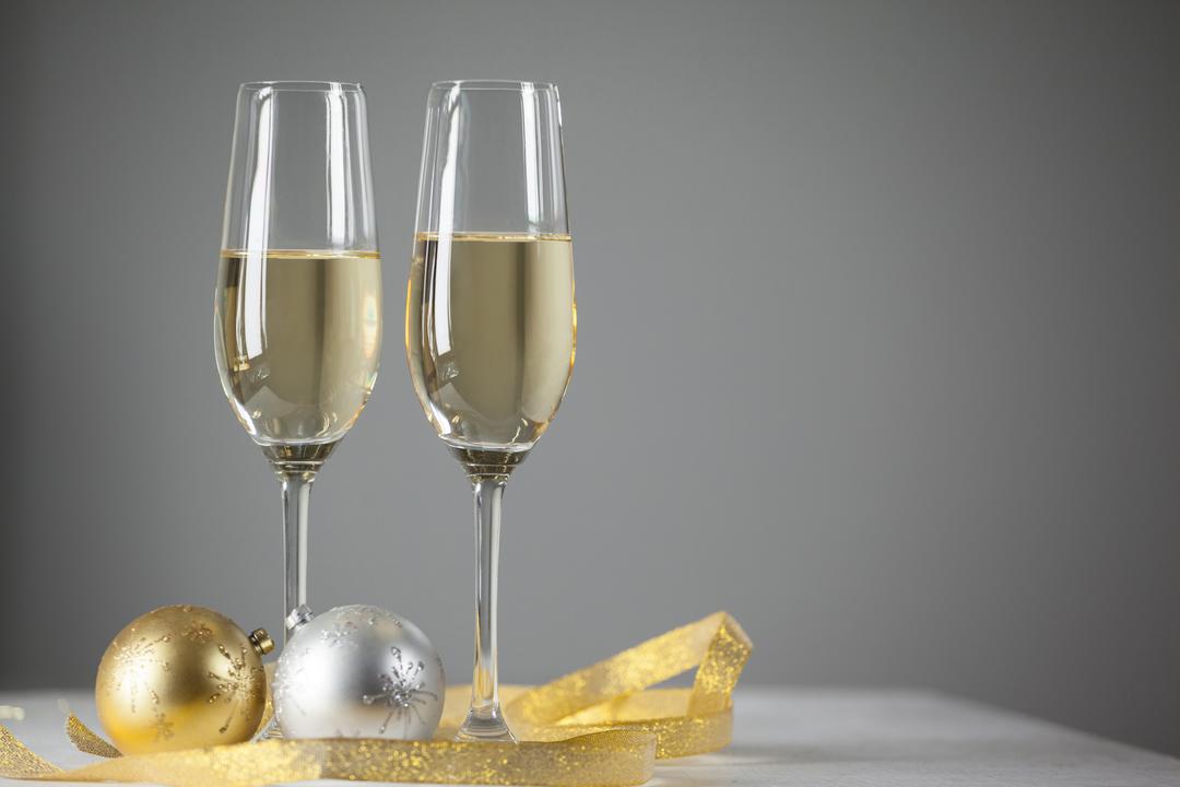 Two champagne flutes and Christmas decoration - Free Images, Stock Photos and Pictures on Pikwizard.com