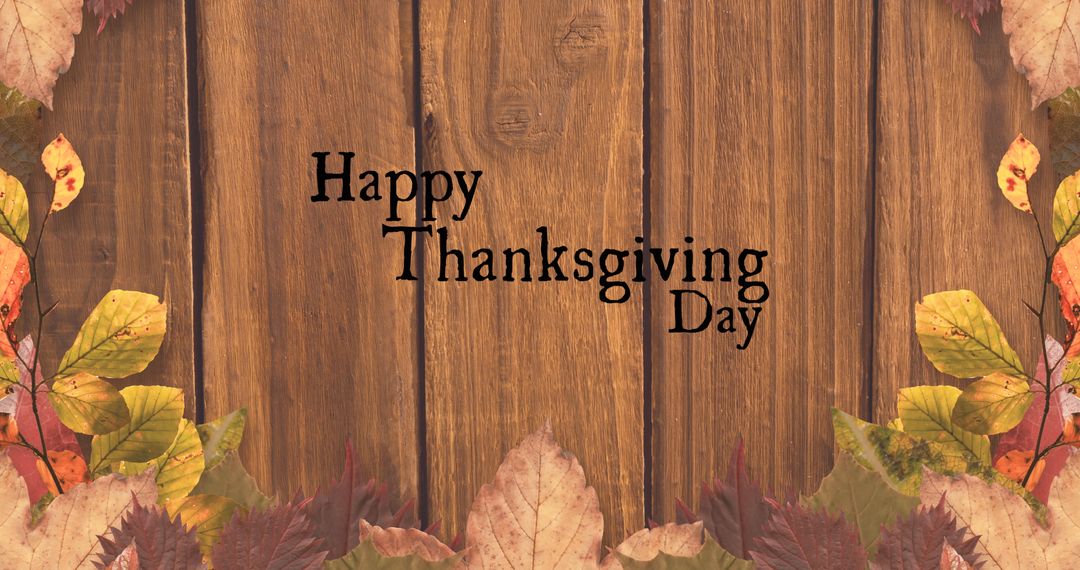 Happy Thanksgiving Day on Wooden Background with Autumn Leaves