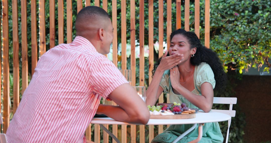 Couple Enjoying Romantic Date with Fruit Platter at Cozy Cafe