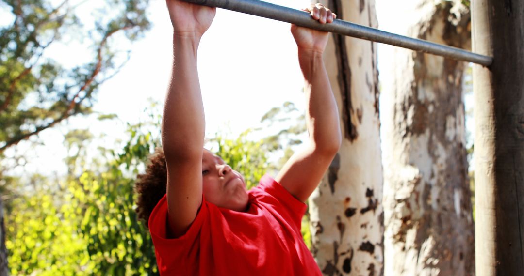 Young Boy in Red Shirt Performing Pull-Ups Outside - Free Images, Stock Photos and Pictures on Pikwizard.com