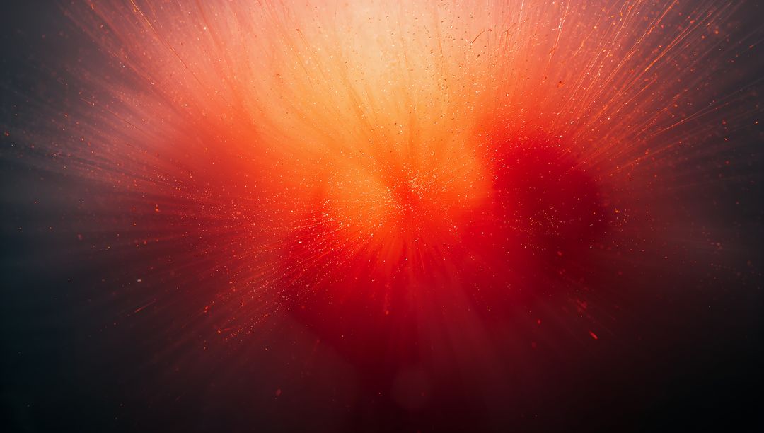 Radiating Core Emitting Orange-Red Light Rays and Glowing Particles in Abstract Gradient