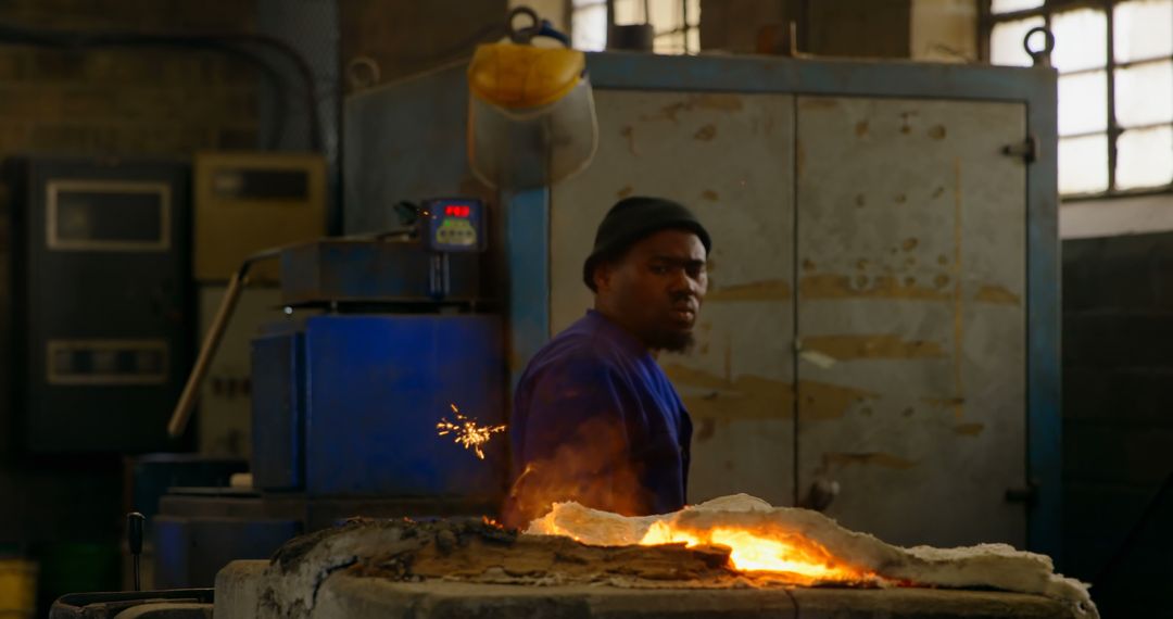 Industrial Worker in Foundry Near Molten Metal and Fire Sparks - Free Images, Stock Photos and Pictures on Pikwizard.com