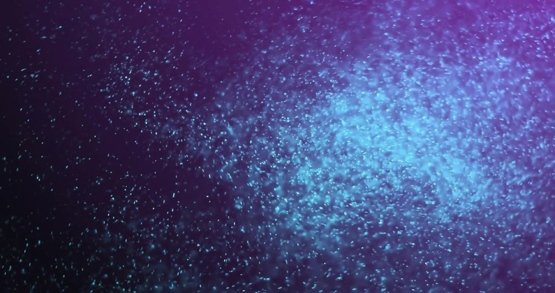 Glowing Blue Particles on Purple Background in Motion