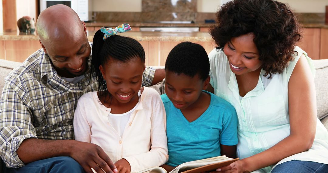 Happy African American Family Reading Together on Cozy Sofa - Free Images, Stock Photos and Pictures on Pikwizard.com