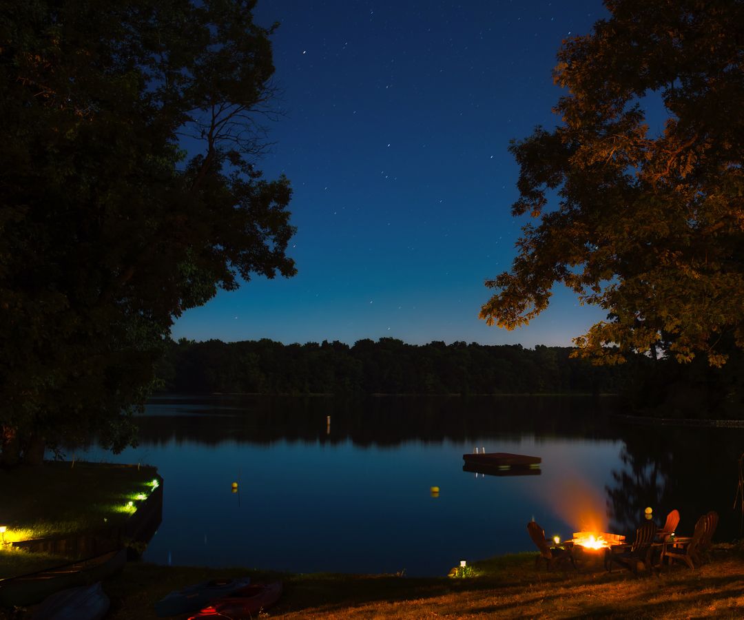 Night Campfire by Tranquil Lake with Starry Sky - Free Images, Stock Photos and Pictures on Pikwizard.com