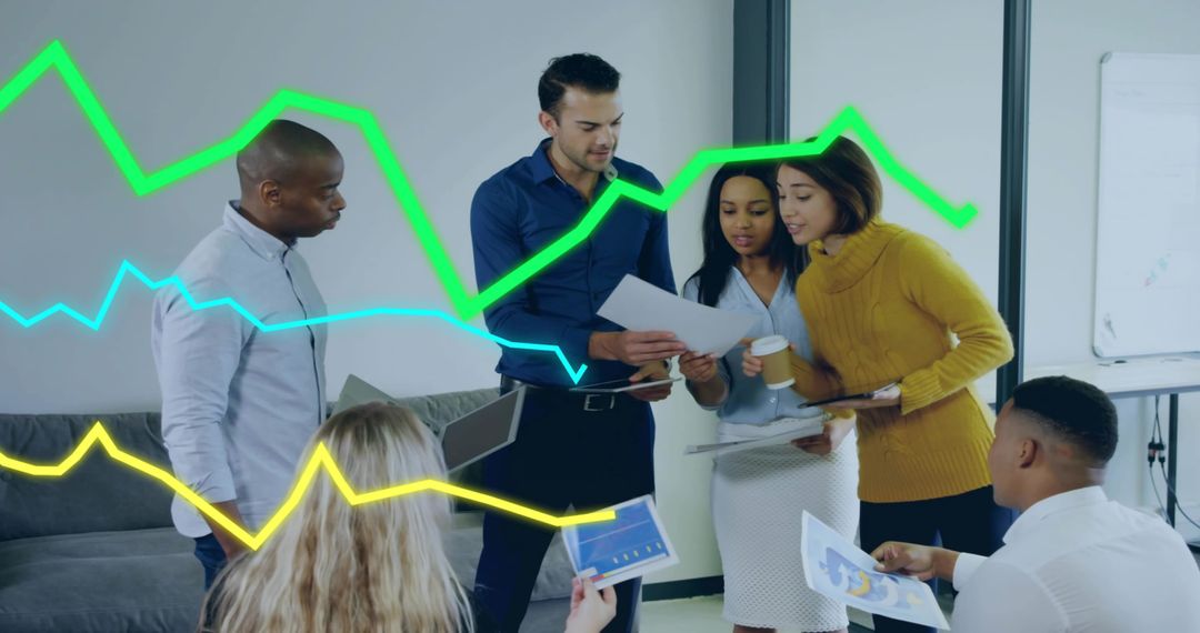 Diverse Business Team Analyzing Sales Trends with Graphs