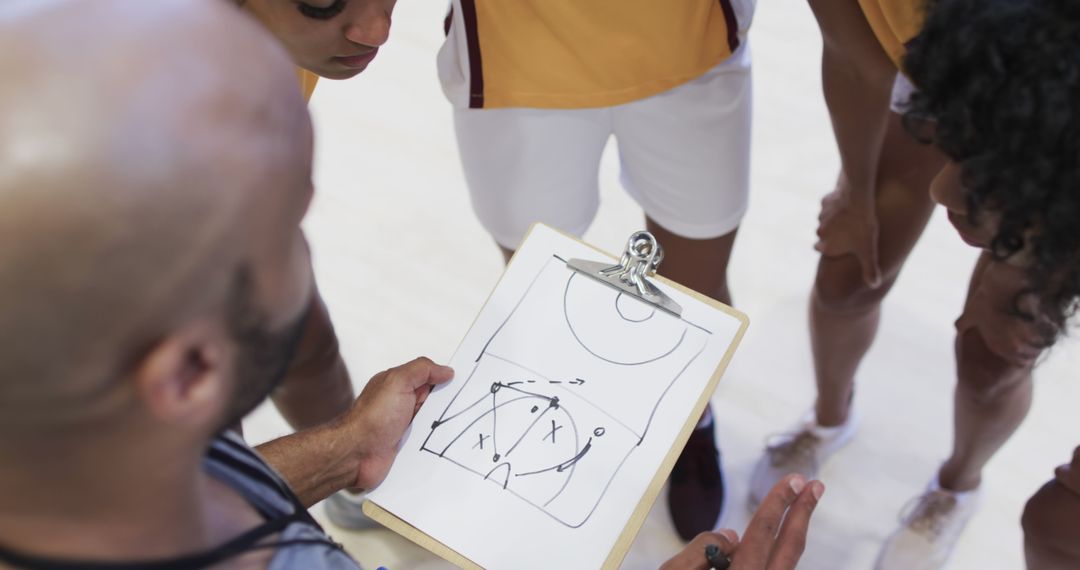 Basketball Team Discussing Game Strategy with Coach - Free Images, Stock Photos and Pictures on Pikwizard.com