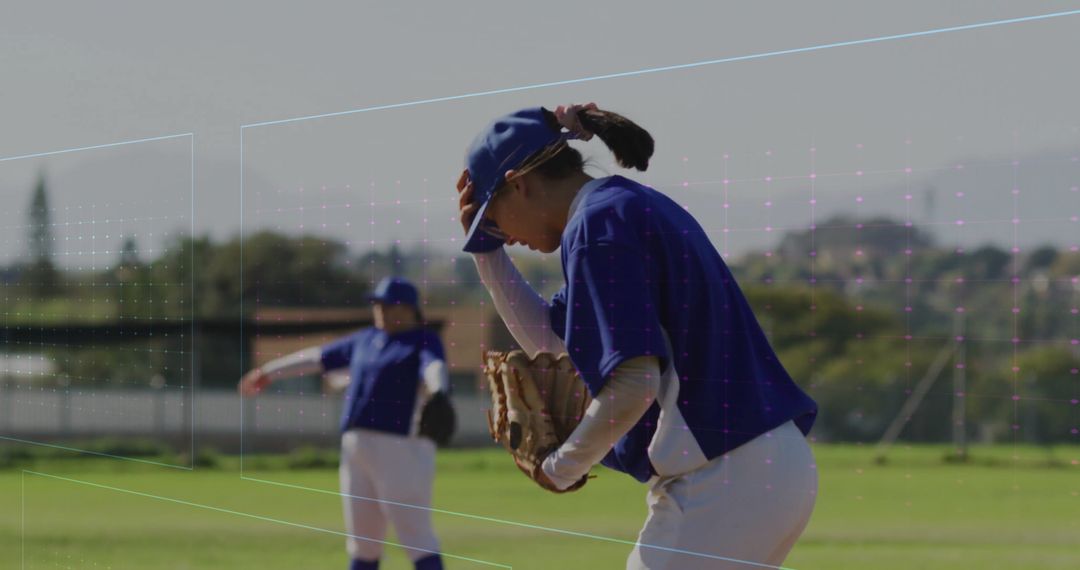 Female Baseball Player Adjusting Cap on Field