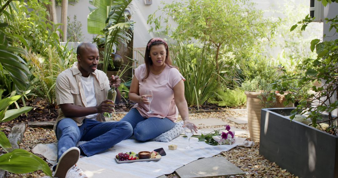 Couple Enjoying Romantic Picnic with Wine in Lush Garden