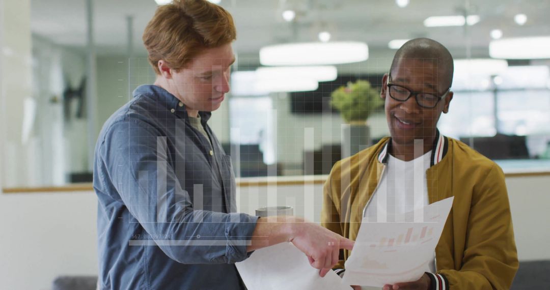 Business Professionals Analyzing Data with Graphs in Modern Office