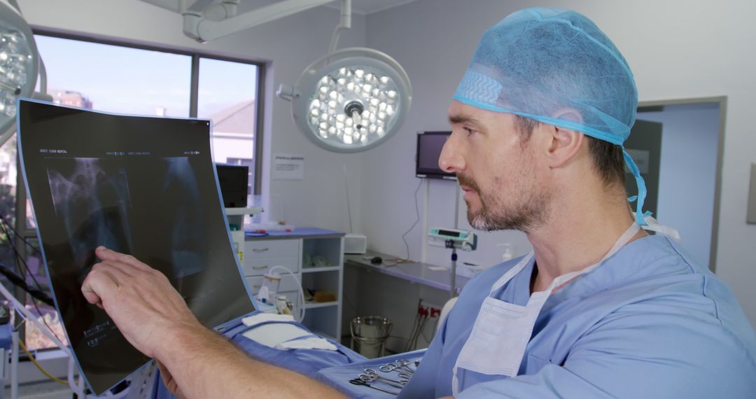 Male Doctor Examining X-ray in Modern Surgery Room - Free Images, Stock Photos and Pictures on Pikwizard.com