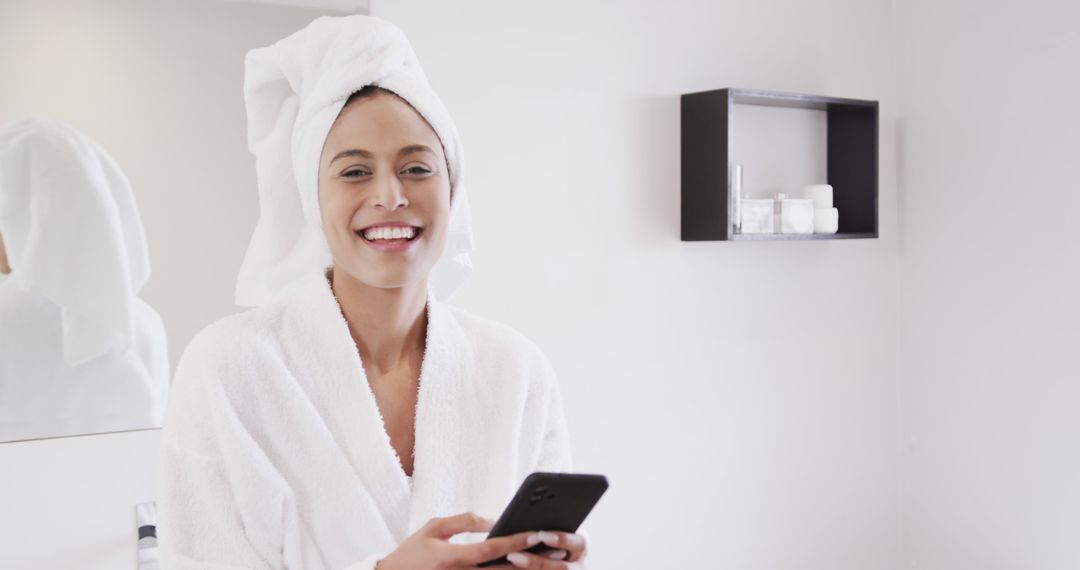 Woman in Bathrobe with Towel on Head Using Smartphone in Bathroom - Free Images, Stock Photos and Pictures on Pikwizard.com