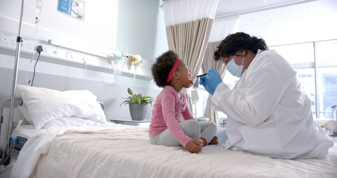 Doctor Examining Child's Throat in Hospital Room - Free Images, Stock Photos and Pictures on Pikwizard.com