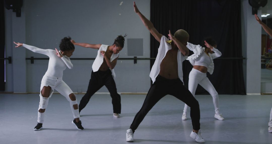 Group of Diverse Dancers Performing Synchronized Dance Moves in Studio - Free Images, Stock Photos and Pictures on Pikwizard.com