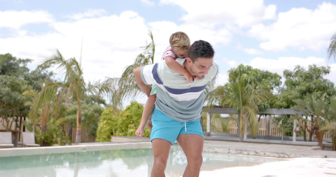 Father Giving Son Piggyback Ride Outdoors by Pool on Sunny Day - Free Images, Stock Photos and Pictures on Pikwizard.com