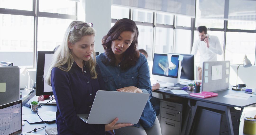 Diverse Female Professionals Collaborating on Project in Modern Office