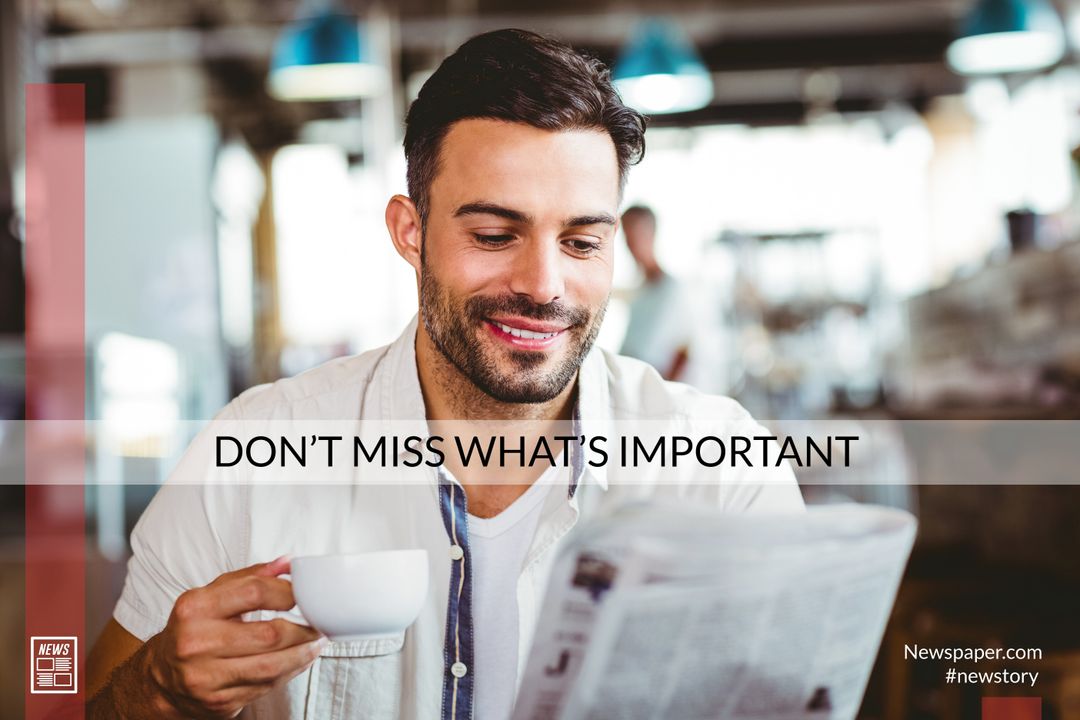 Man reading newspaper while drinking coffee in cafe