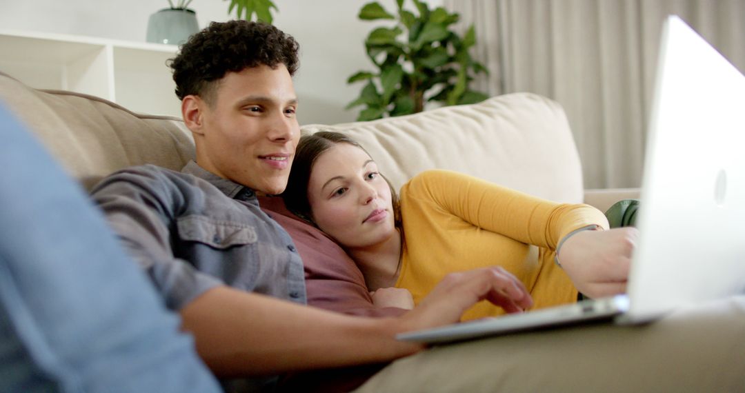 Happy Couple Relaxing Together with Laptop on Couch