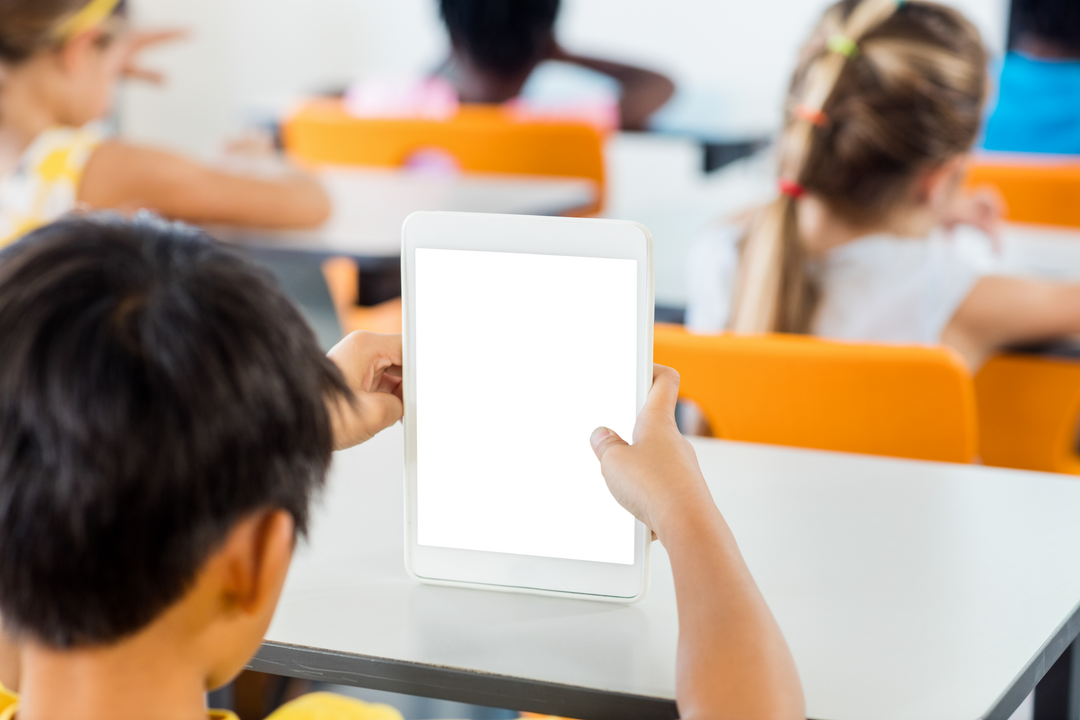 Young Boy Using Transparent Digital Tablet in Classroom - Download Free Stock Images Pikwizard.com