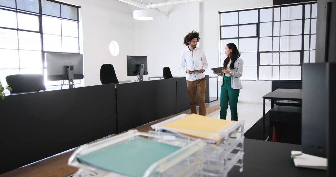 Diverse Colleagues Discussing Work in Stylish Modern Office