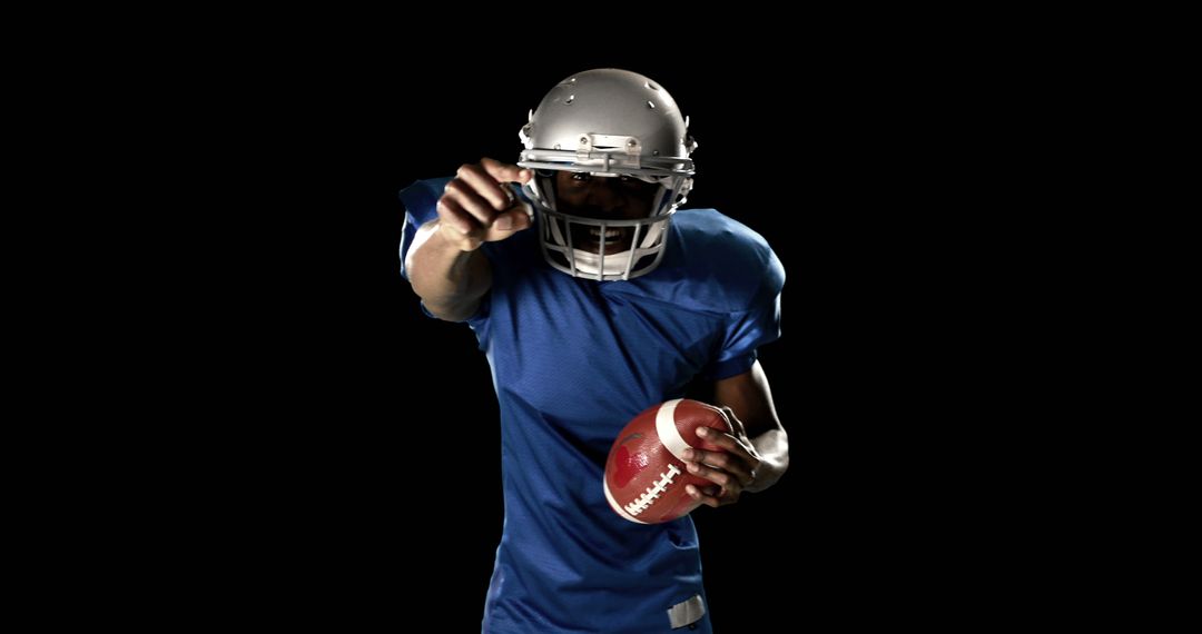 American football player in action holding ball - Free Images, Stock Photos and Pictures on Pikwizard.com