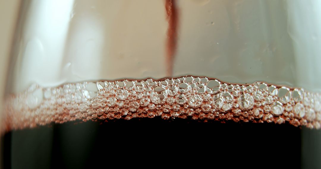 Close-Up of Red Wine with Bubbles in Elegant Glass