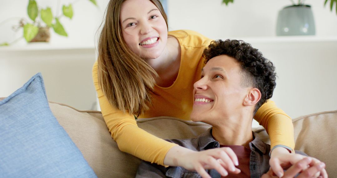 Happy Couple Relaxing and Smiling on Couch at Home