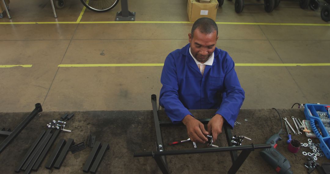 Skilled Worker Assembling Metal Components in Factory - Free Images, Stock Photos and Pictures on Pikwizard.com