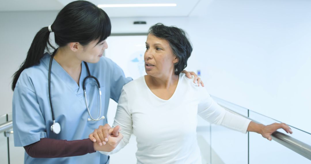 Nurse Caring for Elderly Patient in Hospital Hallway - Free Images, Stock Photos and Pictures on Pikwizard.com