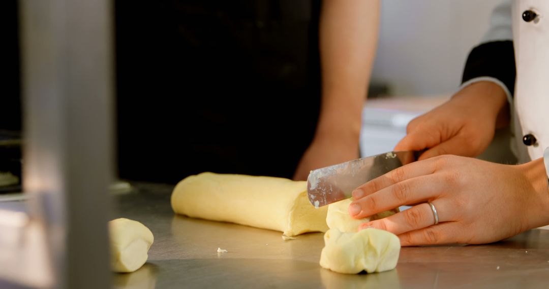 Chef Cutting Dough with Precision in Professional Kitchen