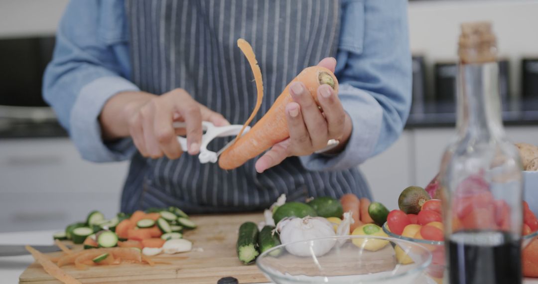 Person Peeling Carrot in Modern Kitchen - Free Images, Stock Photos and Pictures on Pikwizard.com