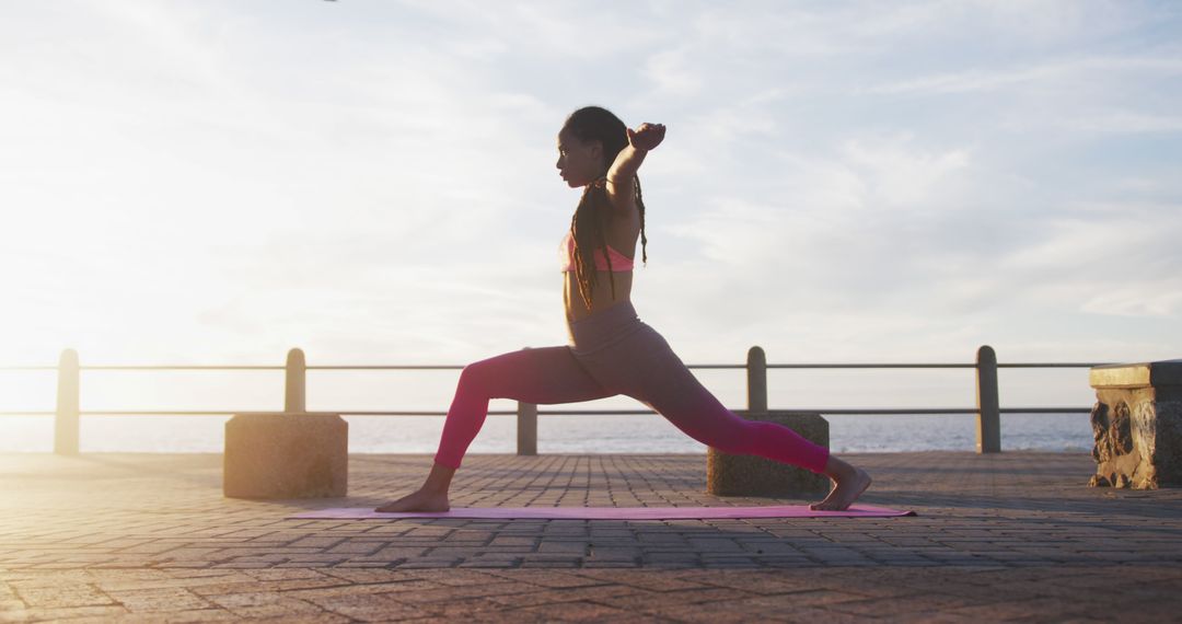 Woman Practicing Yoga Pose Outdoors at Sunrise in Coastal Environment - Free Images, Stock Photos and Pictures on Pikwizard.com