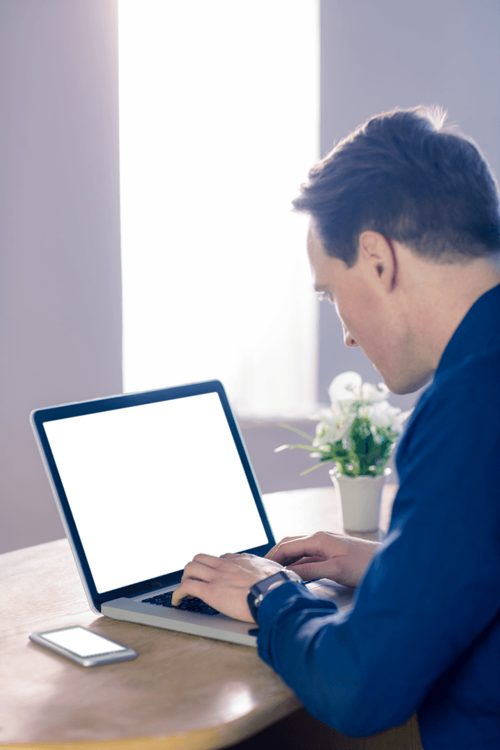 Businessman Working on Laptop with Transparent Screen in Office