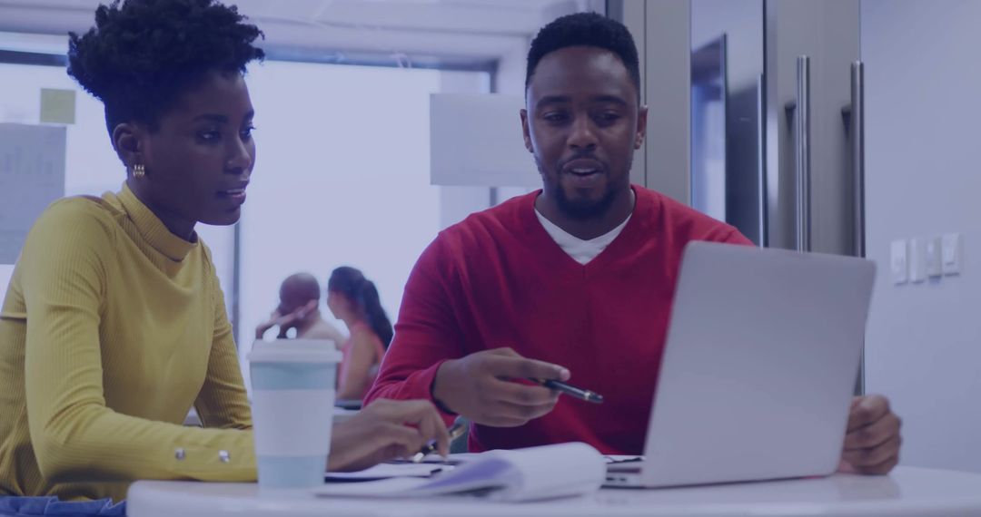 Colleagues Discussing Projections in Modern Office Setting