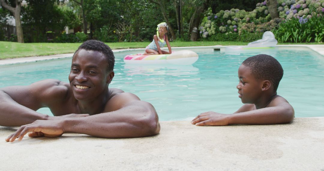 Smiling Father and Son Relaxing in Backyard Pool - Free Images, Stock Photos and Pictures on Pikwizard.com