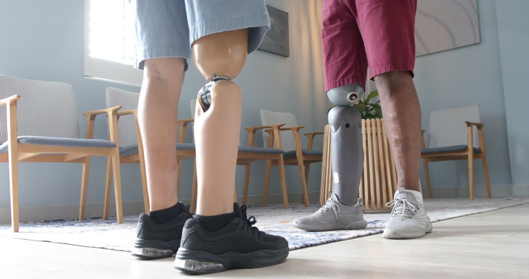 Seniors with Prosthetic Limbs Discussing Therapy Progress in Clinic
