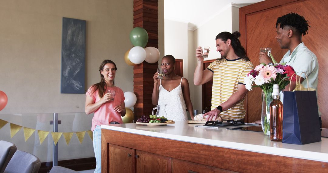 Joyful Friends Celebrating with Toast in Modern Kitchen