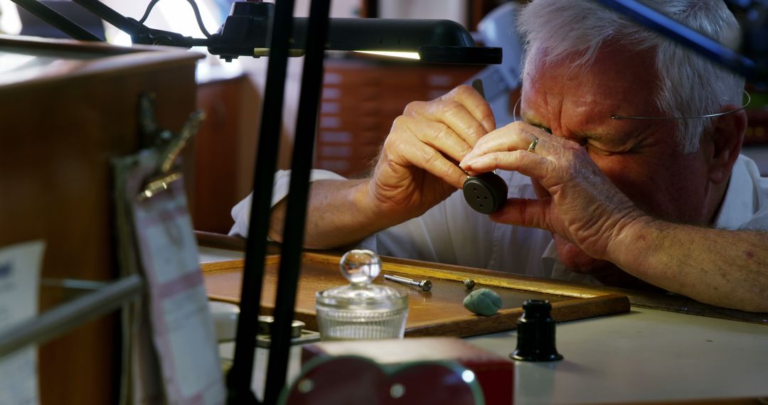 Close-Up of Watchmaker Repairing Timepiece Under Magnifying Glass - Free Images, Stock Photos and Pictures on Pikwizard.com