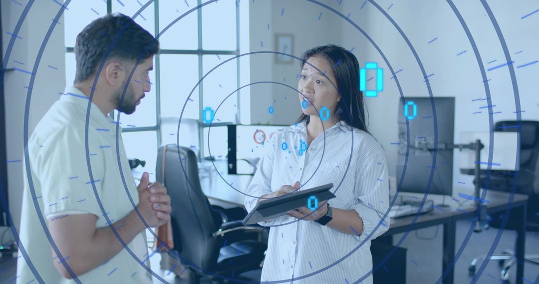 Colleagues Discussing Data Trends with Futuristic AR Overlay in Tech Office