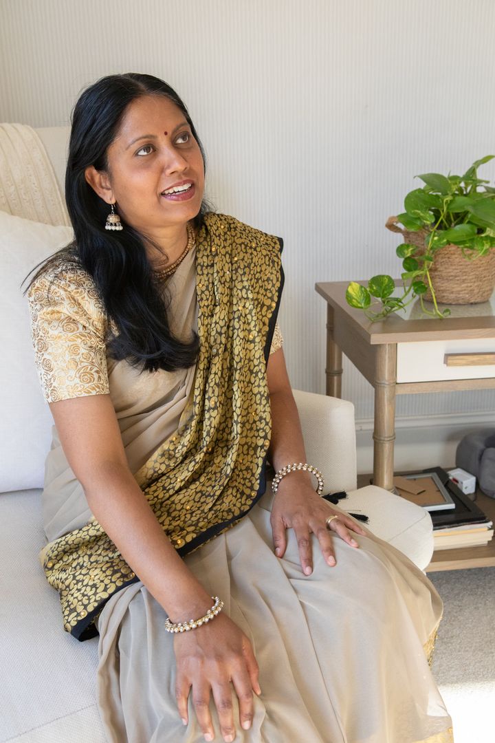 Elegant Woman in Traditional Sari Relaxing in Home Interior