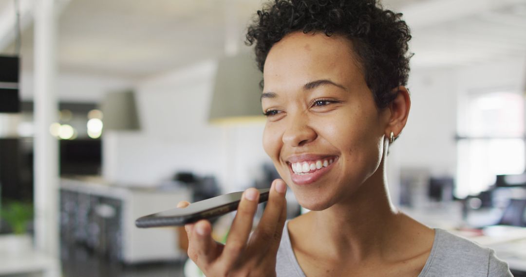 Smiling Businesswoman Making Call in Modern Office Environment