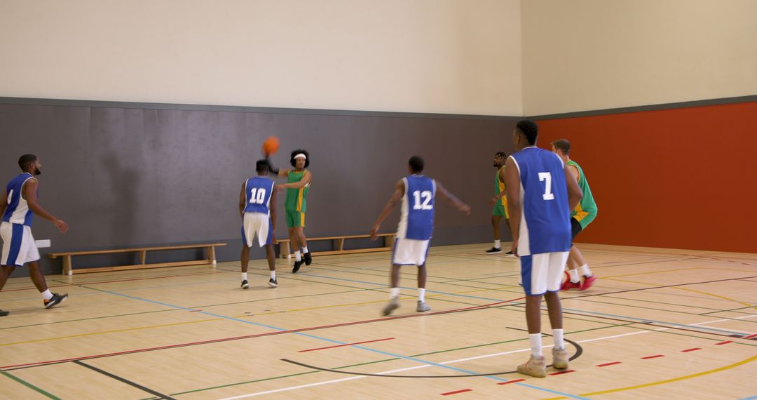 Intense Basketball Game in Indoor Court Featuring Diverse Teams