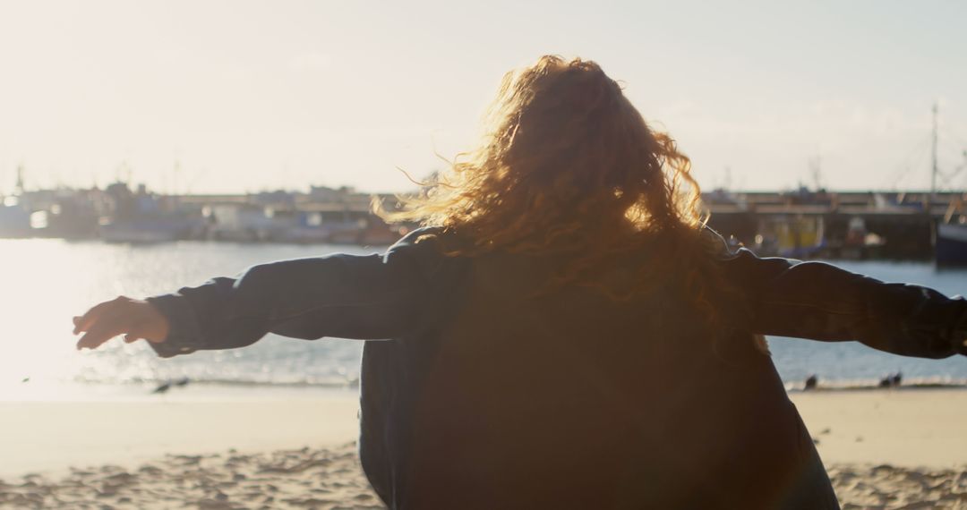 Woman Enjoying Sunset at Beach with Open Arms - Free Images, Stock Photos and Pictures on Pikwizard.com