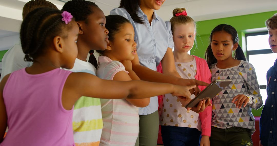 Diverse Children Learning with Teacher on Digital Tablet