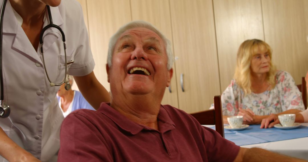 Elderly Man Smiling with Healthcare Worker at Nursing Home - Free Images, Stock Photos and Pictures on Pikwizard.com